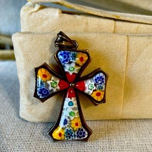 A beautiful Murano glass cross with reds and yellows and blues.